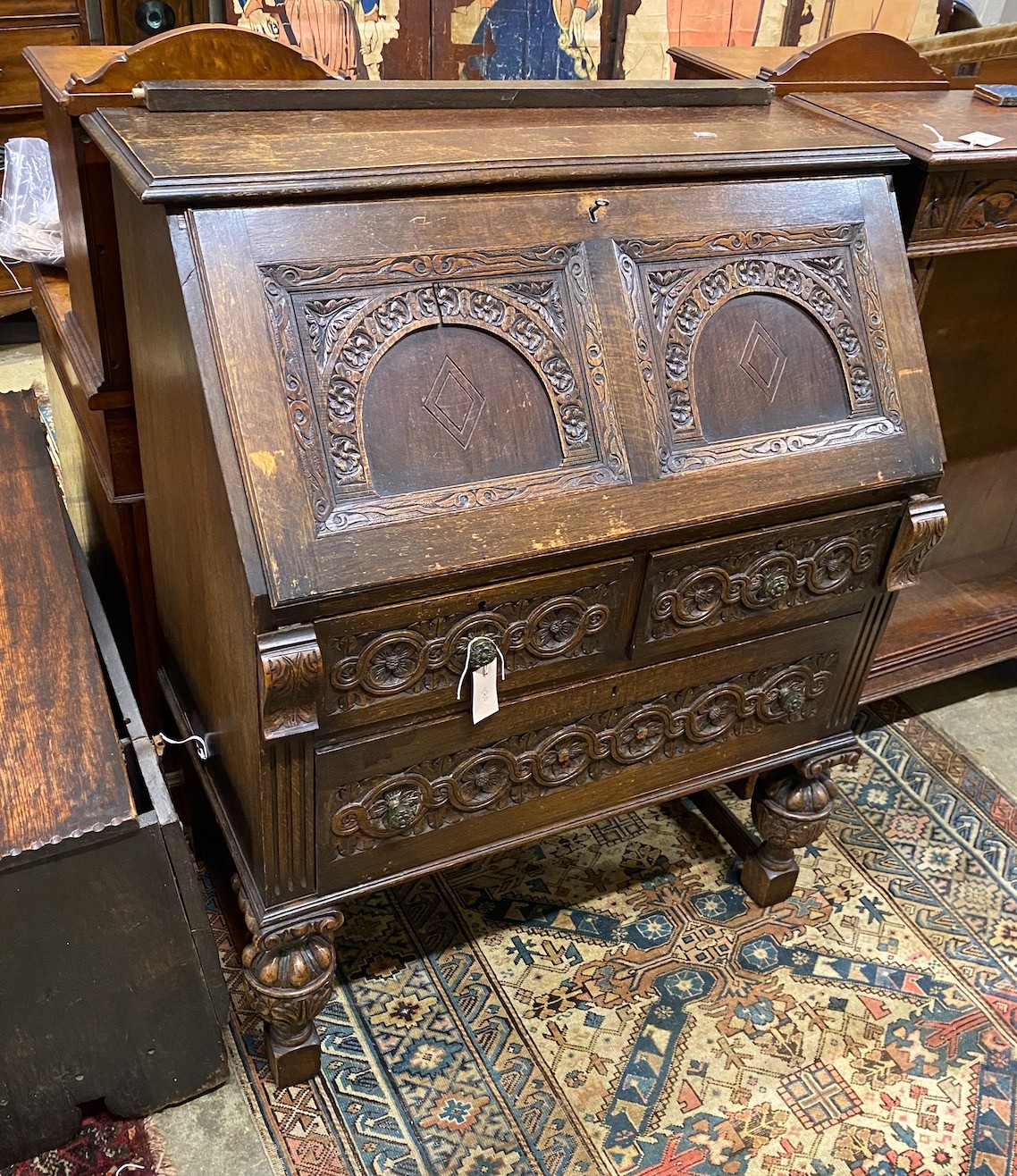 An 18th century style carved oak bureau, width 87cm, depth 47cm, height 106cm